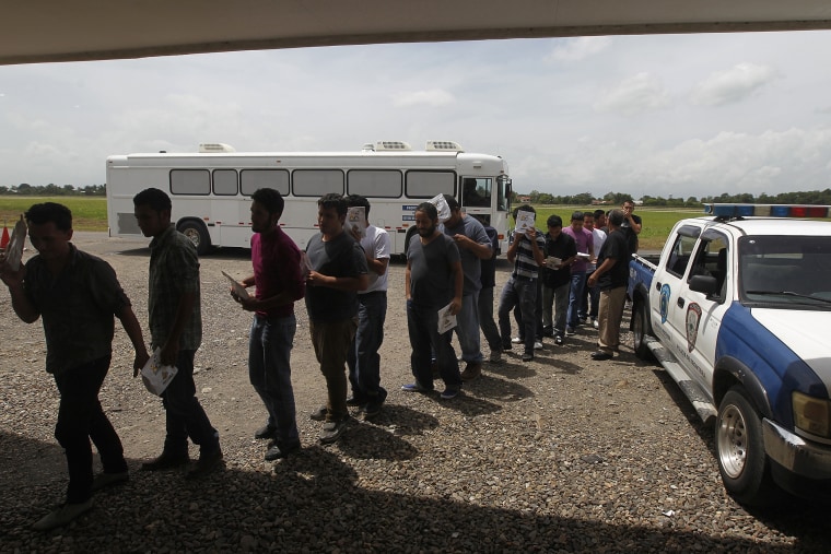 Deportees line up at the Care Center for Returning Migrants (CAMR) after arriving on an immigration flight from the U.S., at the international airport in San Pedro Sula