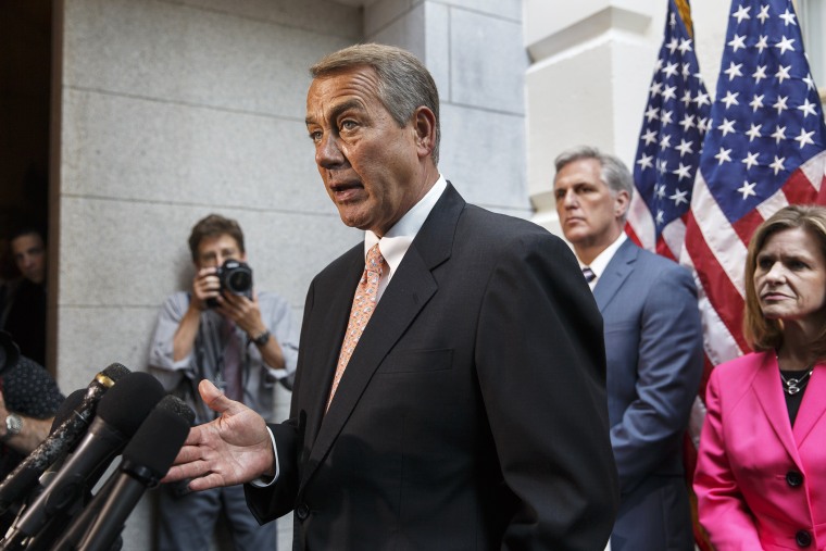John Boehner talks with reporters on Capitol Hill in Washington, Wednesday, July 23, 2014, following a Republican strategy session.