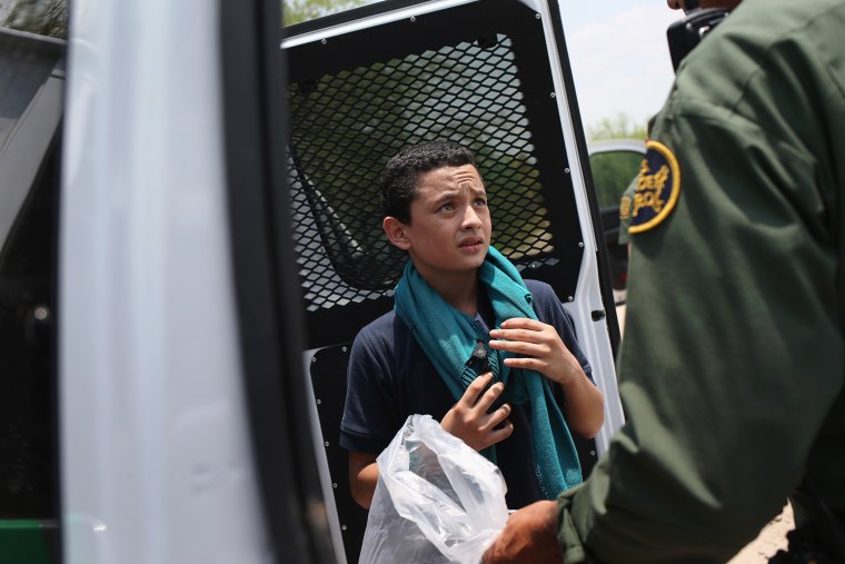 A U.S. Border Patrol agent prepares to take an unaccompanied Salvadorian minor, 13, to a processing center after he crossed the Rio Grande from Mexico into the United States on July 24, 2014 in Mission, Texas.