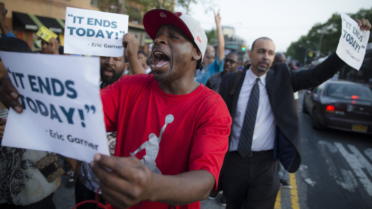 Demonstrators chant as they march towards the 120th Precinct following a vigil demanding justice for Eric Garner, a Staten Island man who died while being arrested by New York City police, on July 22, 2014, in New York.