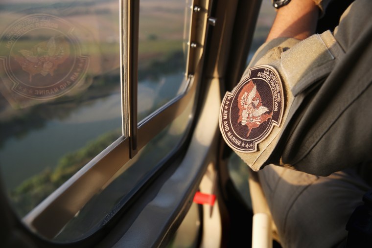 Pilots from the U.S. Office of Air and Marine patrol over the Rio Grande River on July 25, 2014 near Mission, Texas.