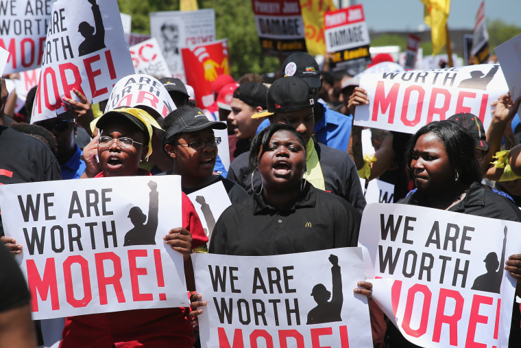 Fast food workers and activists demonstrate outside the McDonald's corporate campus on May 21, 2014 in Oak Brook, Illinois.