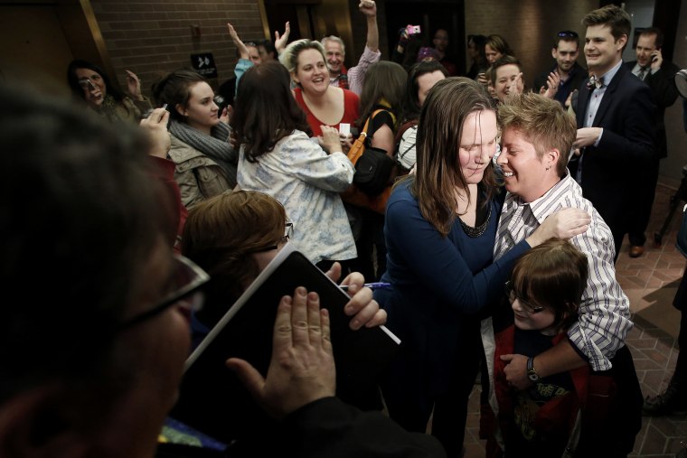 Kim Hackford-Peer marries her partner Ruth Hackford-Peer as Ruth holds their son Casey, 7, at the Salt Lake County office building in Salt Lake City, Utah