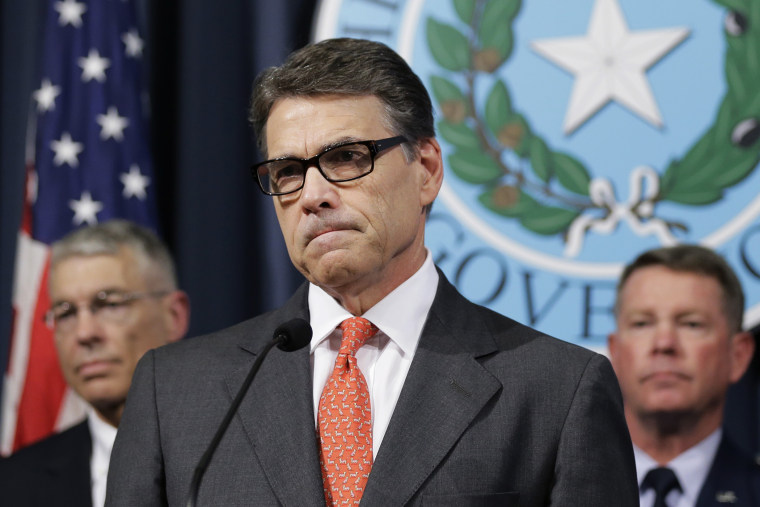 Gov. Rick Perry listens to a reporter's question during a news conference in the Governor's press room, July 21, 2014, in Austin, Texas.