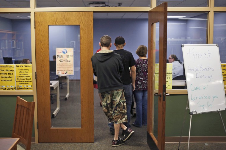 Attendees line up at an Affordable Care Act open enrollment event at a public library in LaGrange, Ky., Oct. 21, 2013.