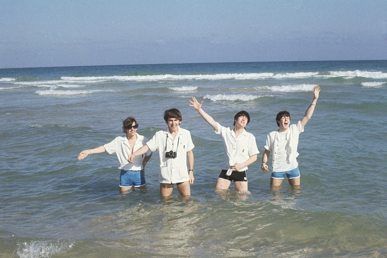 The Beatles wade in the surf at Miami, Florida in February 1964. From left to right are: John Lennon, Paul McCartney, George Harrison and Ringo Starr. (AP Photo)