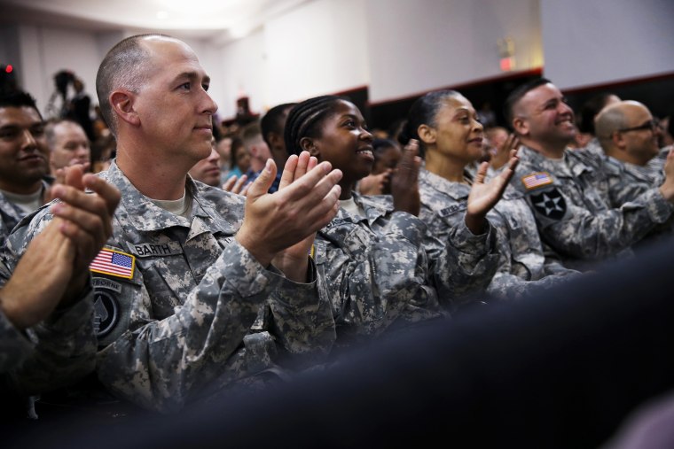 Members of the military applaud as President Barack Obama speaks about the Veteransâ Access to Care through Choice, Accountability, and Transparency Act, Aug. 7, 2014.