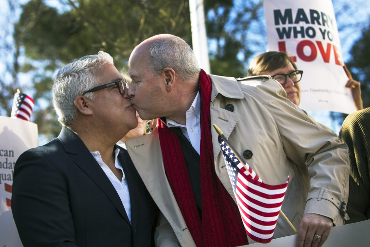Robert Roman and Claus Ihlemann, of Virginia Beach, celebrate Thursday's ruling that Virginia's same-sex marriage ban was unconstitutional, Feb. 14, 2014, in Norfolk, Va.