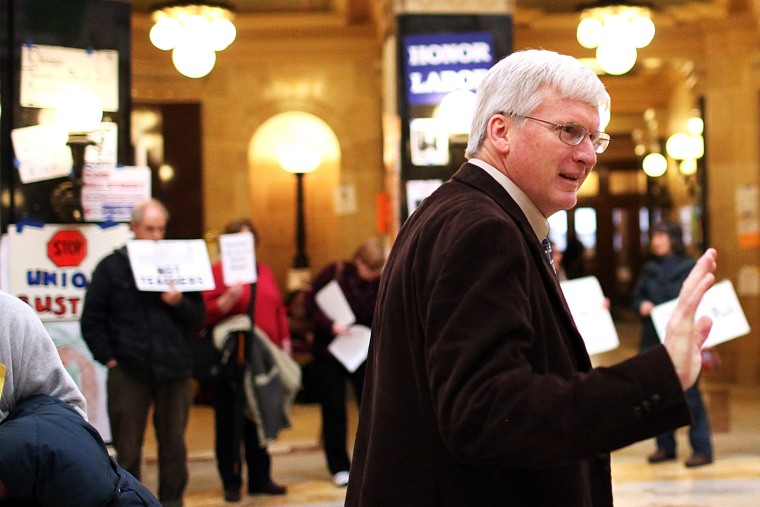 Republican Wisconsin State Senator Glenn Grothman waves as he walks through the Wisconsin State Capitol.