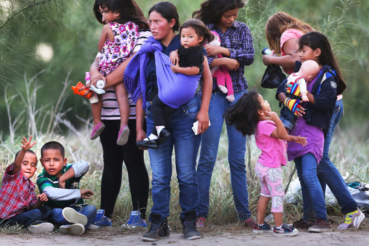 Central American immigrants await transportation to a U.S. Border Patrol processing center after crossing the Rio Grande from Mexico into the Texas on July 24, 2014 near Mission, Texas.