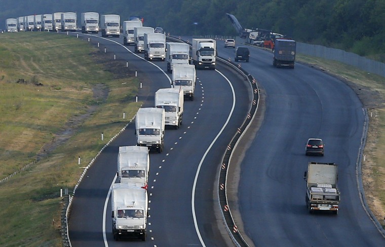 A Russian convoy of trucks carrying humanitarian aid for Ukraine travels along a road south of the city of Voronezh