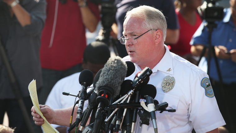 Standing in the parking lot of a gas station which was burned during rioting, Ferguson Police Chief Thomas Jackson announces the name of the Ferguson police officer responsible for the August 9, shooting death of teenager Michael Brown on August 15, 2014