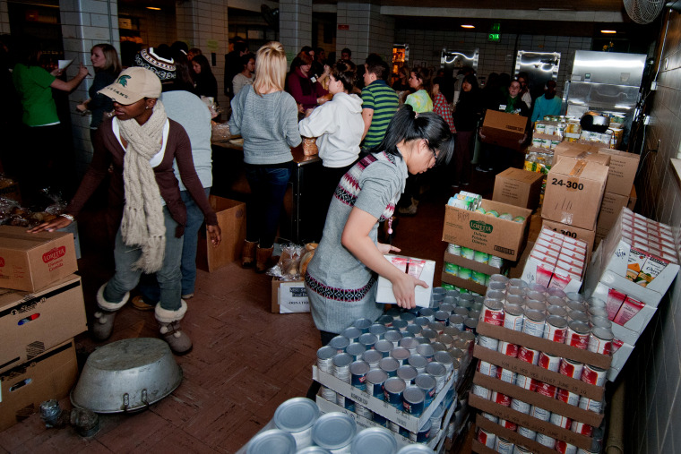 Staff and student volunteers fill orders at the Michigan State University Student Food Bank on Feb. 23, 2011