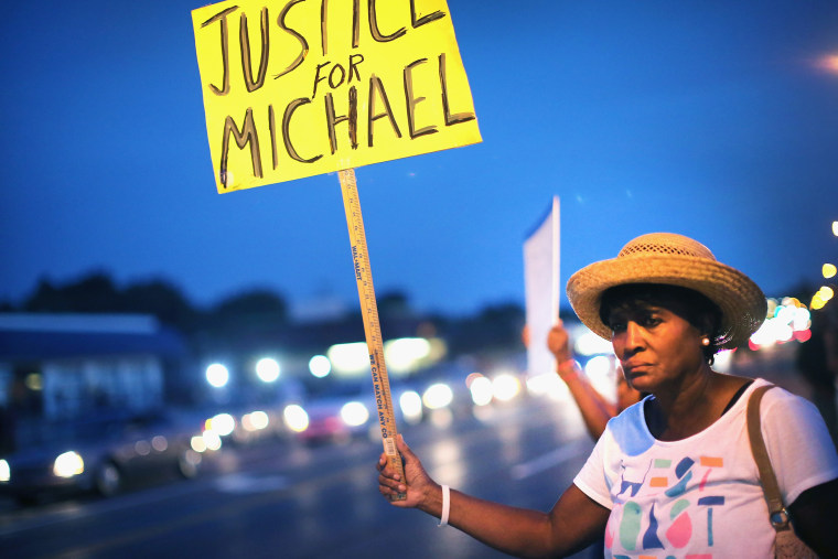 Gwen Stewart joins other demonstrators along West Florissant Avenue to protest the shooting death of Michael Brown on August 14, 2014 in Ferguson, Missouri.
