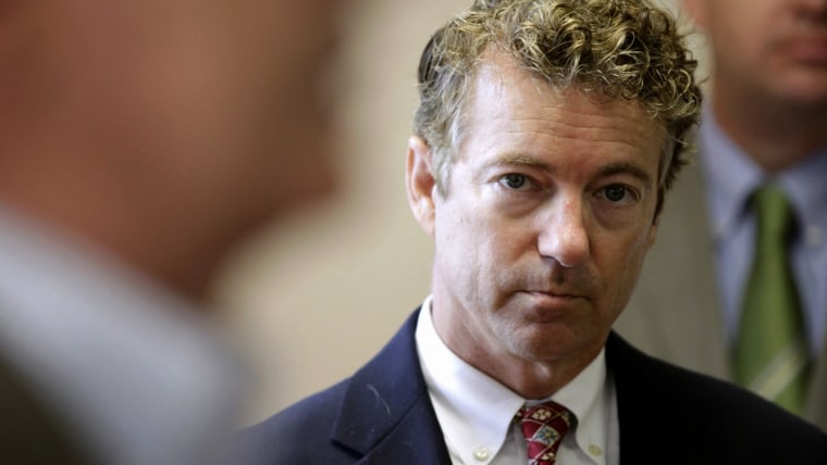 Sen. Rand Paul, R-Ky. listens as he is introduced to speak during a meeting with local Republicans, Tuesday, Aug. 5, 2014, in Hiawatha, Iowa.