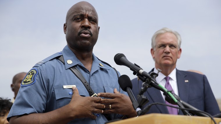 Capt. Ron Johnson of the Missouri Highway Patrol, left, answers questions as Gov. Jay Nixon listens during a news conference Friday, Aug. 15, 2014, in Ferguson, Mo.