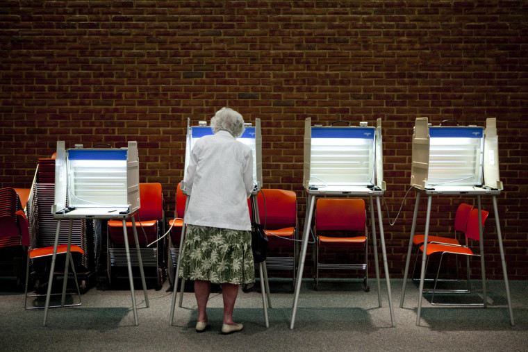A voter casts her ballot in the primary election in Maryland Heights, Missouri, August 3, 2010.