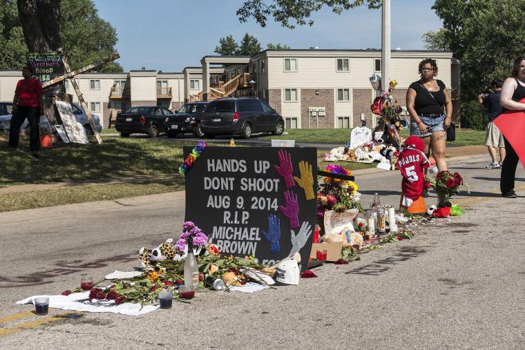 A small memorial marks the place where Michael Brown's body fell after being killed by a police officer in Ferguson, Mo.