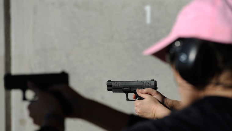 People shoot their guns at a shooting range in Tucson, Arizona.