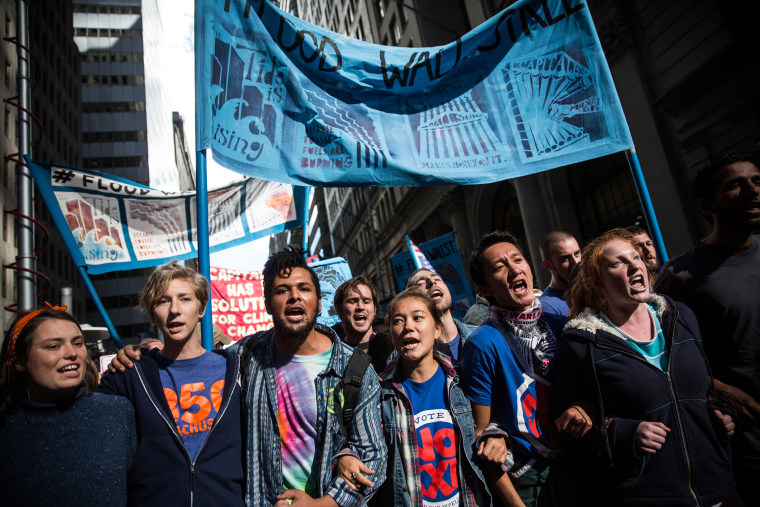 Protesters demanding economic and political changes to curb the effects of global warming march toward the New York Stock Exchange on September 22, 2014 in New York City.