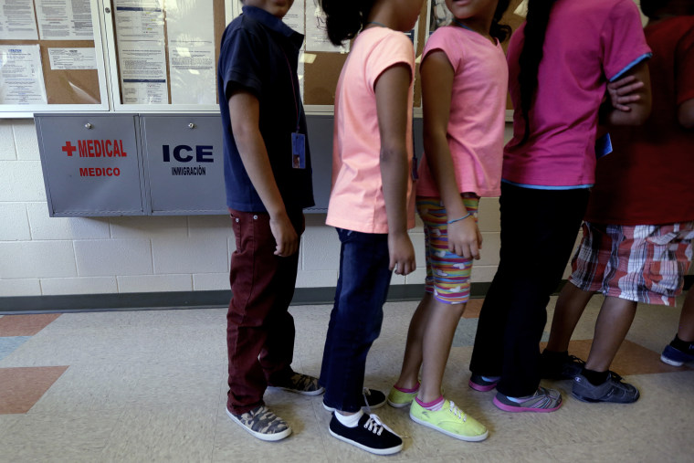 Detained immigrant children line up in the cafeteria at the Karnes County Residential Center, a temporary home for immigrant women and children detained at the border, on Sept. 10, 2014, in Karnes City, Texas.