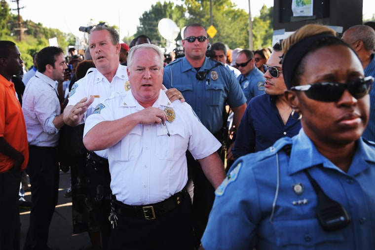 Ferguson Police Chief Thomas Jackson leaves the parking lot of a gas station, which was burned during rioting, after he announced the name of the Ferguson police officer responsible for the August 9, shooting death of teenager Michael Brown on August 15,