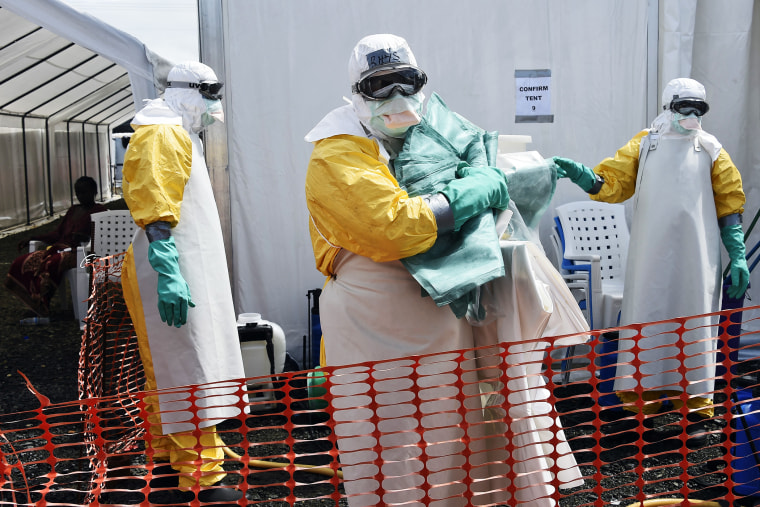 A health worker in protective suit carries equipment on October 1, 2014 at MSF's (Doctors Without Borders) Ebola treatment center in Monrovia.