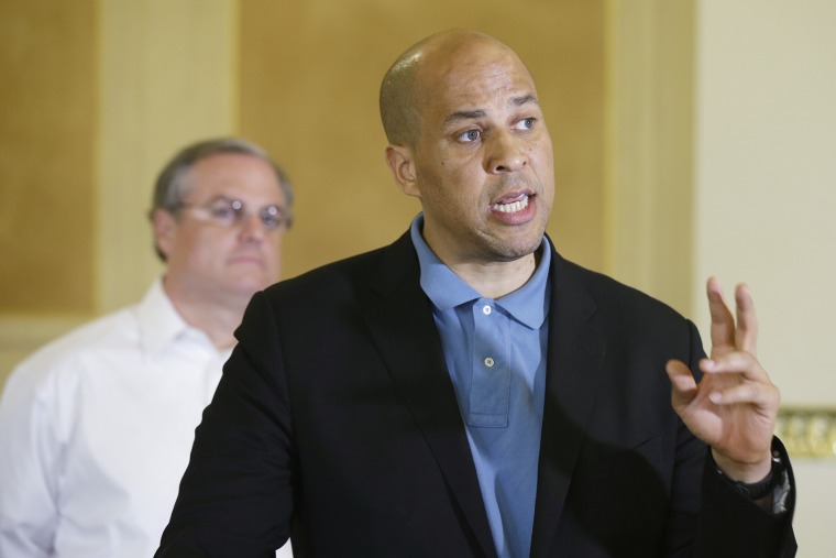 U.S. Sen. Cory Booker, D-N.J., right, speaks during a news conference at the Arkansas state Capitol in Little Rock, Ark., as U.S. Sen. Mark Pryor listens on May 31, 2014.