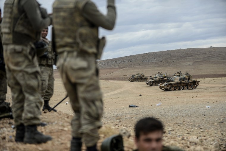 Turkish army tanks take position near the Syrian border on Sept. 29, 2014 in Suruc after three mortars hit the Turkish side.