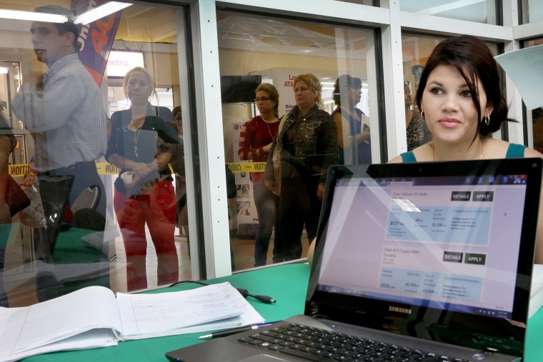 A woman tries to purchase health insurance under the Affordable Care Act at the Mall of Americas on January 15, 2014 in Miami, Florida.