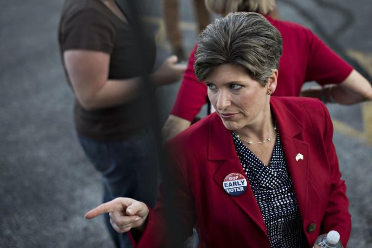 Republican Joni Ernst, running for the U.S. Senate in Iowa, gestures toward a supporter outside the Scott County GOP headquarters during a campaign stop in Davenport, Iowa, on Sept. 25, 2014.