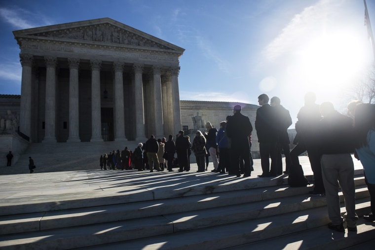 People wait in line to enter the U.S. Supreme Court on the first day of January sessions in Washington, Jan. 13, 2014.