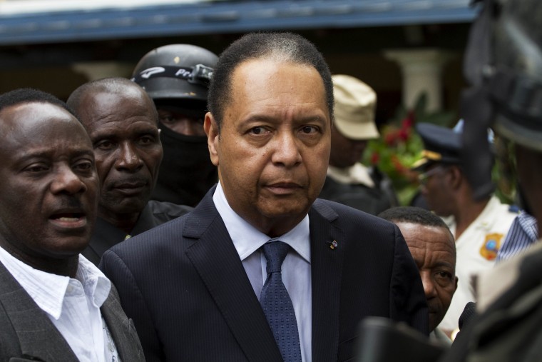 Haiti's ex-dictator Jean-Claude Duvalier is escorted out of his hotel in Port-au-Prince, Haiti Jan. 18, 2011. (Photo by Ramon Espinosa/AP)