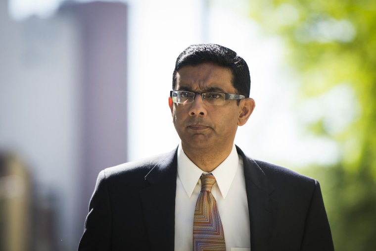 Dinesh D'Souza exits the Manhattan Federal Courthouse after pleading guilty in New York, May 20, 2014.