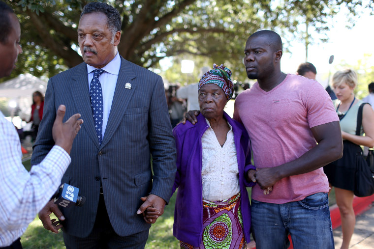 Rev. Jesse Jackson (L) stands with Nowai korkoyah (C) the mother of Ebola patient Thomas Eric Duncan, as well as his nephew, Josephus Weeks, as they speak to the media at the Texas Health Presbyterian hospital on October 7, 2014 in Dallas, Texas.