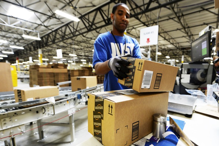 Employee Lamar Roby prepares shipping orders at Amazon's San Bernardino Fulfillment Center October 29, 2013 in San Bernardino, California.