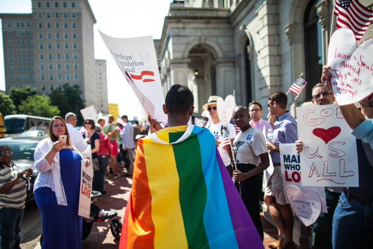 A same-sex marriage supporter wears a rainbow cape behind 4th U.S. Circuit Court of Appeals after a court hearing  May 13, 2014 in Richmond, Virginia.