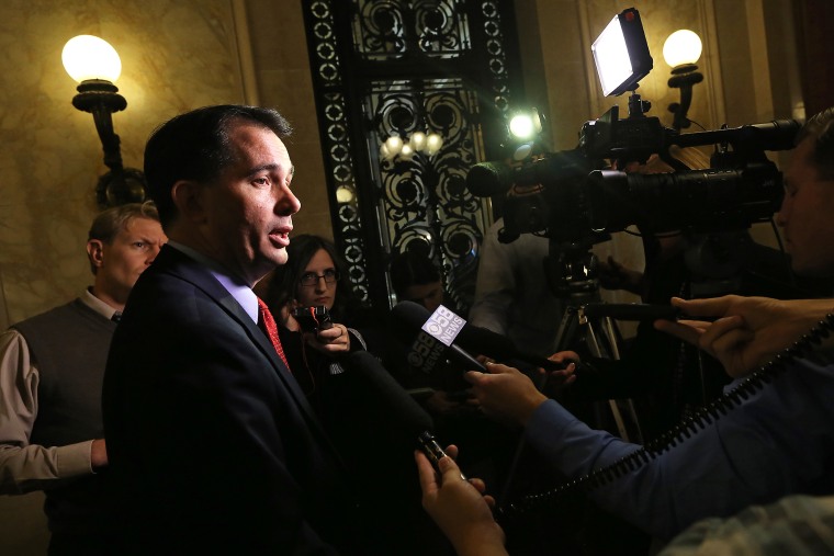 Wisconsin Gov. Scott Walker speaks to members of the media at the Wisconsin State Capitol building in Madison, Wis. on Oct. 6, 2014. (Photo by John Hart/Wisconsin State Journal/AP)