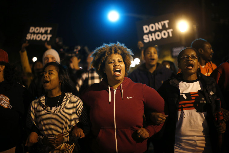 Protesters link arms after blocking an intersection after a vigil in St. Louis, Missouri, on Oct. 9, 2014.