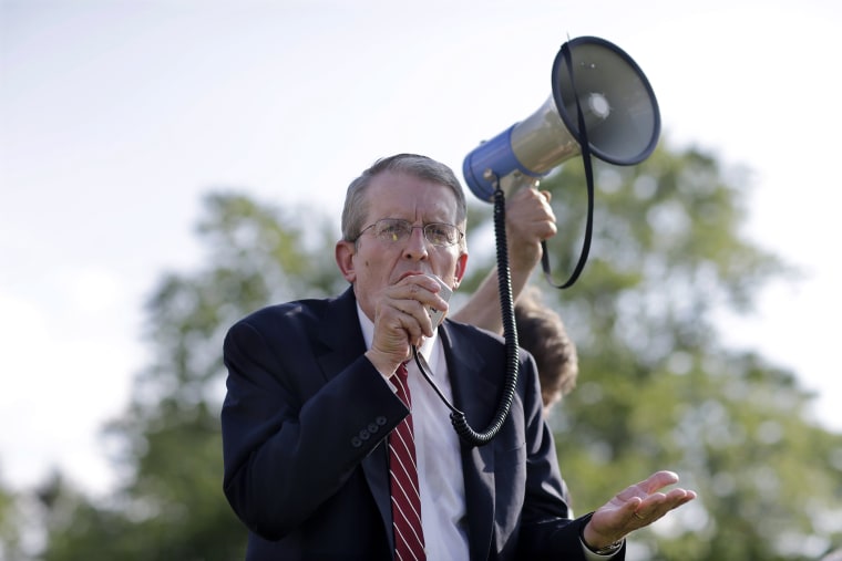 In this Monday, Aug. 4, 2014 photograph, Jeff Bell uses a bullhorn to address a gathering in Cherry Hill, N.J.