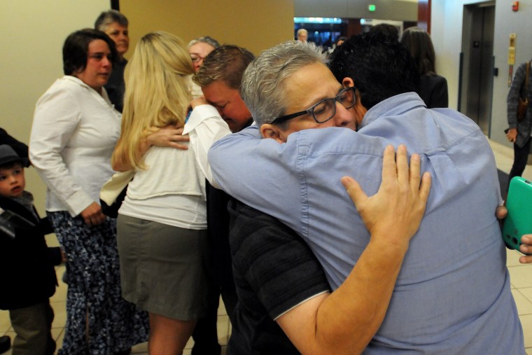 Jody May-Chang hugs her wife Maria May-Chang in the Ada County Courthouse Wednesday morning after copuples were denied a marriage license on Oct. 8, 2014 in Boise, Idaho. (Photo by Adam Eschbach/The Idaho Press-Tribune/AP)