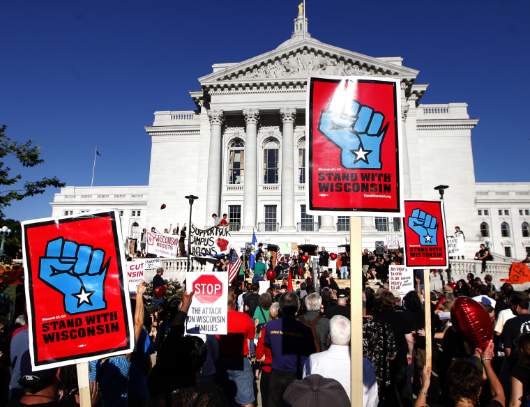 Hundreds of labor union members and supporters march into the Wisconsin State Capitol Building during a rally to protest the collective bargaining measures...