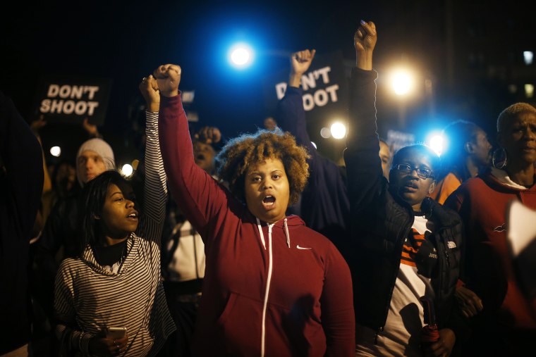 Protesters cheer after blocking an intersection after a vigil in St. Louis, Mo. on Oct. 9, 2014. (Photo by Jim Young/Reuters)