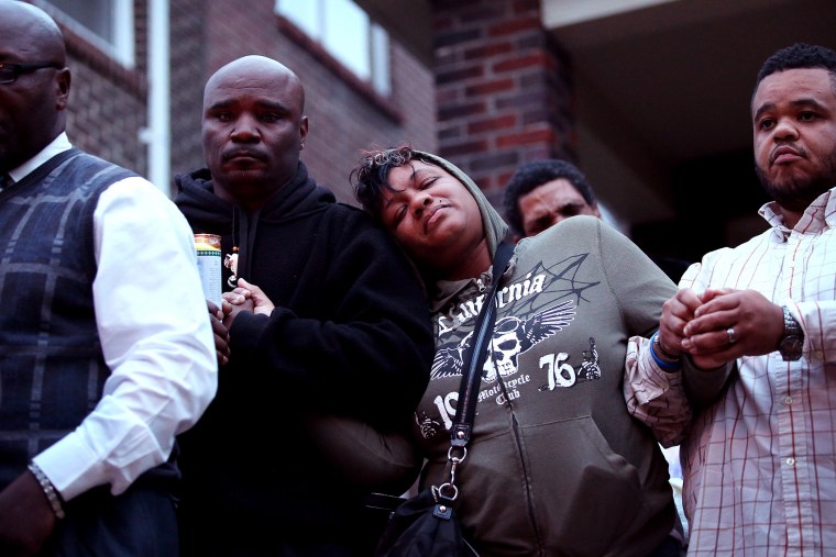 Family members attend a candlelight vigil for 18-year-old Vonderrit Myers Jr. on Oct. 9, 2014 in St Louis, Mo. Meyers was shot and killed by an off duty St. Louis police officer.