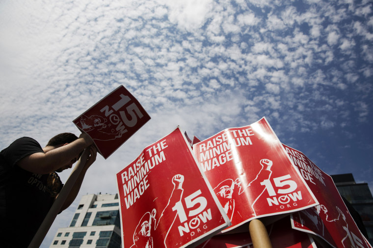 Demonstrators prepare signs supporting the raising of the federal minimum wage during May Day demonstrations in New York, N.Y., on May 1, 2014. (Photo by Lucas Jackson/Reuters)