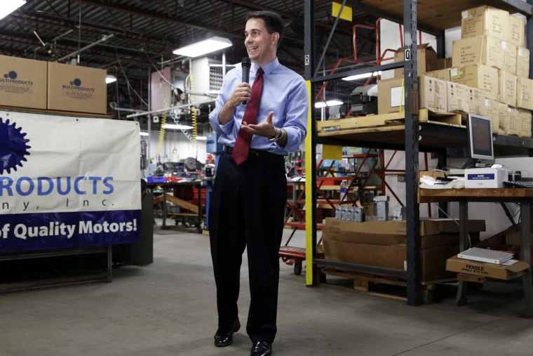 Republican Wisconsin Gov. Scott Walker campaigns for re-election at a manufacturing company in Racine, Wis. on Sept. 23, 2014.