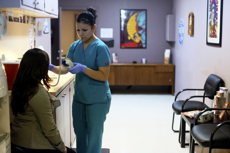 Nyla Munoz, a medical assistant, helps a patient through a pre-op appointment during the final day of seeing patients at Whole Women's Health Clinic, an abortion clinic, in McAllen, Texas.