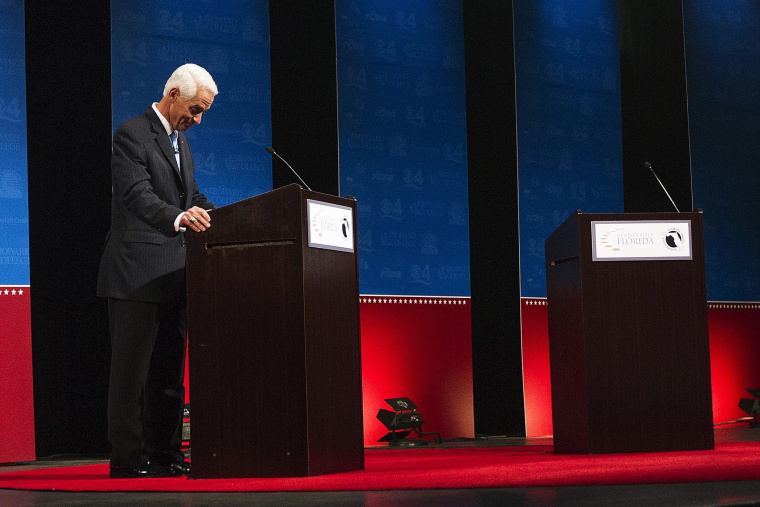 Former Florida Governor and challenger, Charlie Crist, appears alone for the first few minutes of a their gubernatorial debate, as Florida Governor Rick Scott delays taking the stage on Oct. 15, 2014.