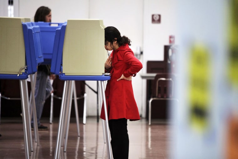 Wendy Mena, 18, studies her choices as she votes in her first election in Cary, N.C. on Nov. 6, 2012.