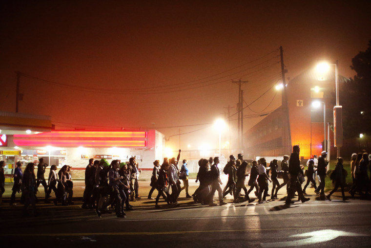Demonstrators march through the street on Oct. 13, 2014 in St Louis, Mo. (Photo by Scott Olson/Getty)